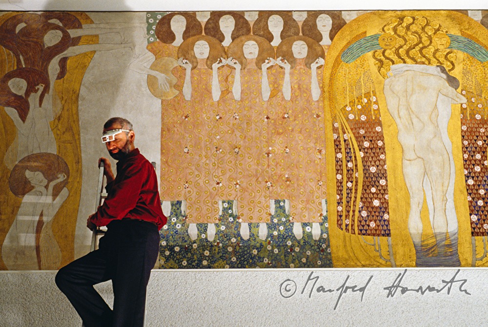 conservator with magnifying glasses checks the painting