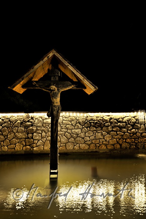 crucifix in the pond of the spring