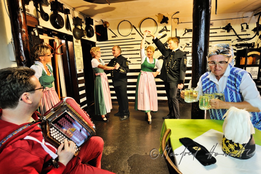 men in miners clothes and women dance in the mining museum